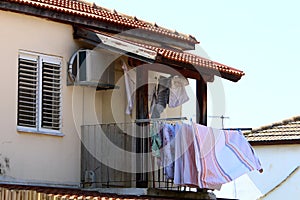 The washed clothes are dried on a clothesline outside the apartment window