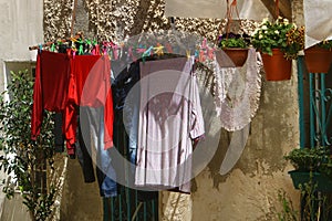 The washed clothes are dried on a clothesline outside the apartment window