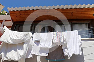 The washed clothes are dried on a clothesline outside the apartment window