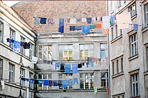 Washed clothes drying outside of an old house. Washed clothes drying. Fresh clean clothes are drying outside. Clothes