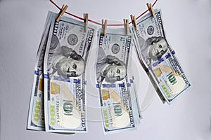 Washed dollars, closeup photo of one hundred dollar banknotes on white background. Macro shot