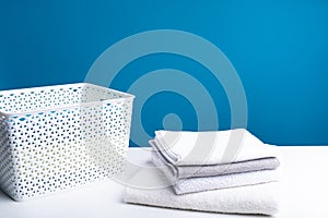 Washed linens on table together with laundry box