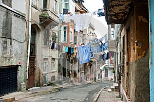 Washed shirts on a rope between old houses of narrow street of Istanbul