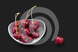 Washed sweet cherries on a black background. Prunus avium