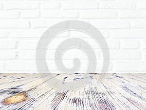 Washed wood table with white brick wall texture background