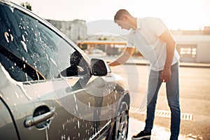 Washer rubbing vehicle with foam, car wash