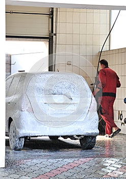 Washerman washing Car at Car-wash service