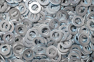 Washers for the bolt. Texture. Many washers for bolts and screws. Background for wallpaper. Shim. Spacer