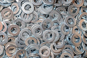 Washers for the bolt. Texture. Many washers for bolts and screws. Background for wallpaper. Shim. Spacer