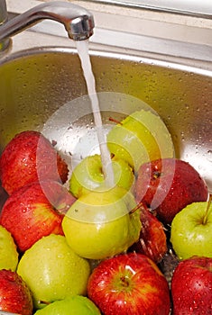 Washing apples fruits in the kitchen