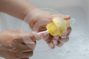 Washing baby nipples. Mother`s hand washing the baby nipples