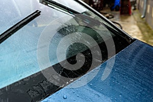 Washing car windscreen with wipers and liquid