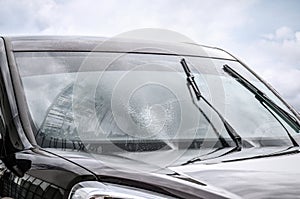 Washing car windscreen with wipers and liquid photo