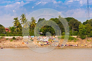 Washing clothes on the river Irrawaddy, Mandalay, Myanmar, Burma. Copy space for text.