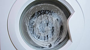 Washing clothing in generic white domestic washing machine