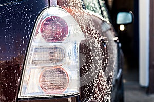 Washing a dirty car with foam