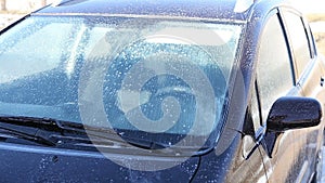 Washing a dirty car with foam