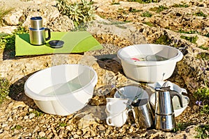 Washing dishes outdoors, capming photo