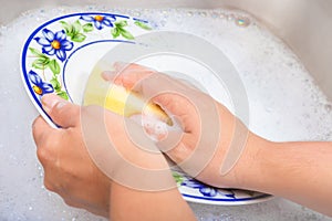 Washing the dishes on soapy water