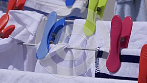 Brightly coloured clothes pegs on a washing line