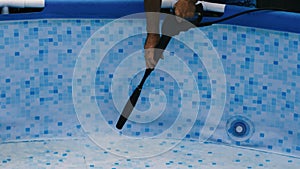 Washing a frame pool with a high pressure washer. Home pool cleaning concept