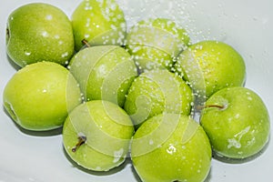 Washing fruit. Wet apples in the shower.