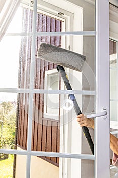 Washing the glass surface of the window with a steam generator brush