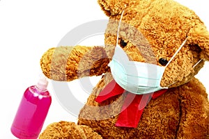 Washing hands concept of a large teddy bear pressing a soap dispenser