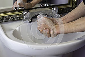 Washing hands in domestic bathroom to prevent spread of coronavirus