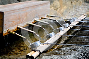 Washing hands in the Izumo Taisha Shrine in Shimane, Japan. To pray, Japanese people usually clap their hands 2 times, but for thi