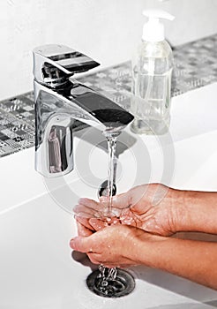 Washing hands in modern sink