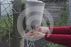 Washing of hands in an old rural washstand