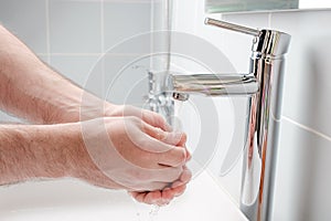 Washing hands with soap in the bathroom