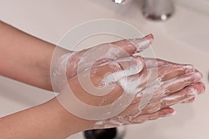 Washing hands with soap foam photo