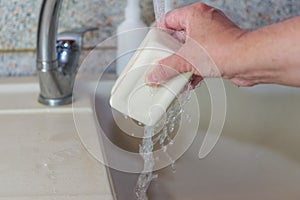 Washing hands with soap in the sink against the background of antiseptics. Disease prevention, personal hygiene