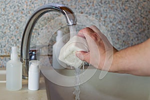 Washing hands with soap in the sink against the background of antiseptics. Disease prevention, personal hygiene