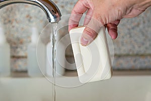 Washing hands with soap in the sink against the background of antiseptics. Disease prevention, personal hygiene