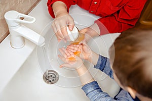 Washing hands with soap under the faucet with water. Clean and Hygiene