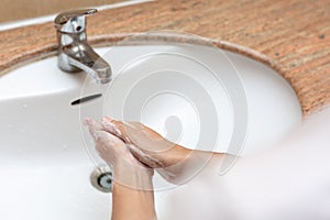 Washing of hands with soap under running water