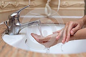 Washing of hands with soap under running water