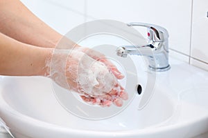 Washing of hands with soap under running water