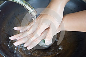 Washing of hands with soap under running water