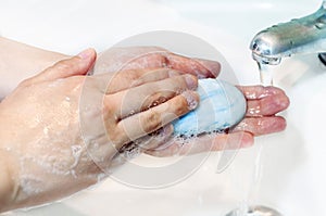 Washing of hands with soap under running water