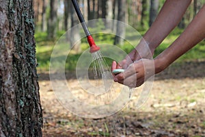 washing hands in the solar shower with soap while camp photo