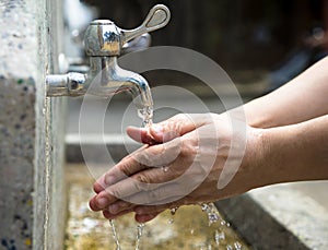 Washing of hands under running water