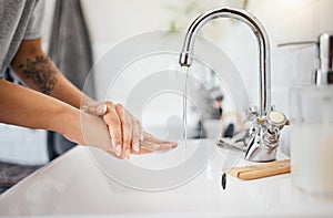 Washing hands, water or covid bacteria cleaning in home bathroom, kitchen sink or house tap. Zoom on woman in safety or