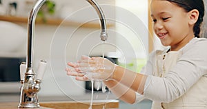 Washing hands, water and happy girl child in kitchen for hygiene, safety or responsibility at home. Smile, cleaning and