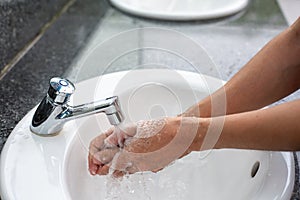 Washing hands in water running