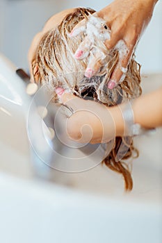 Washing the head of a girl in a beauty salon