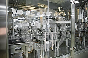 Washing industrial machine for plastic PET bottles, conveyor line or belt preparing for filling with beverage